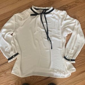 LOFT cream blouse with black tie and trim.